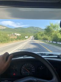 Person seen through car windshield