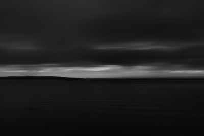 Scenic view of sea against storm clouds