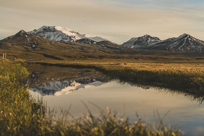 Scenic view of lake and mountains against sky