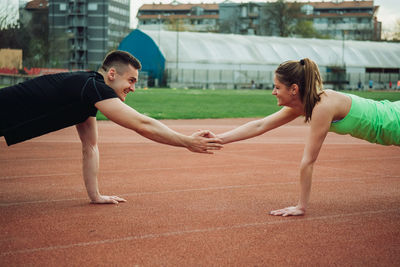 Friends exercising on sports track