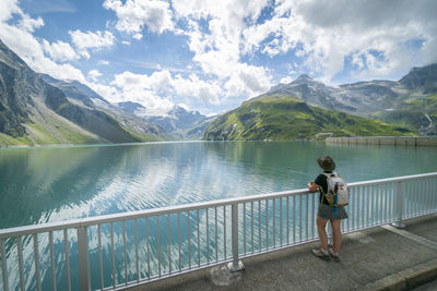 Rear view of man standing by railing