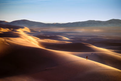 Scenic view of desert against sky during sunset