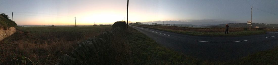 Panoramic view of farm against sky during sunset