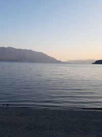 Scenic view of sea against clear sky during sunset