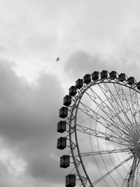 Low angle view of ferris wheel against sky