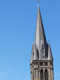 Low angle view of building against clear blue sky