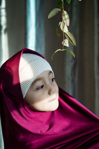 Portrait of a happy muslim toddler girl with hijab. natural light, selective focus.