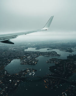 Cropped image of airplane wing over river