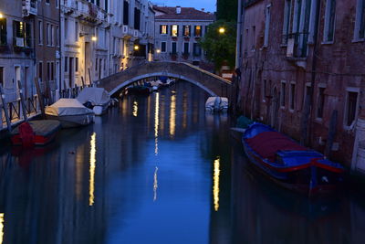 View of boats moored at canal