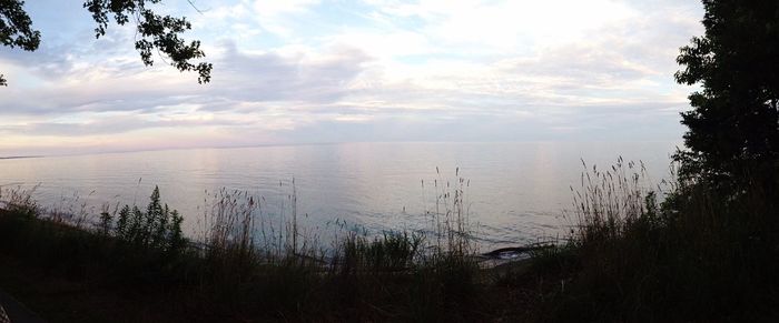 Scenic view of sea against cloudy sky