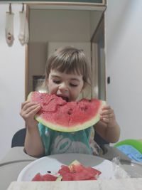 Portrait of cute girl eating food