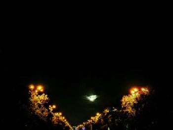 Low angle view of illuminated street light at night