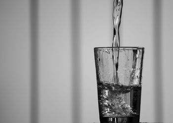 Close-up of glass pouring water