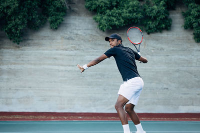 Full length of man playing tennis