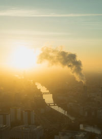 Aerial view of city against sky during sunset