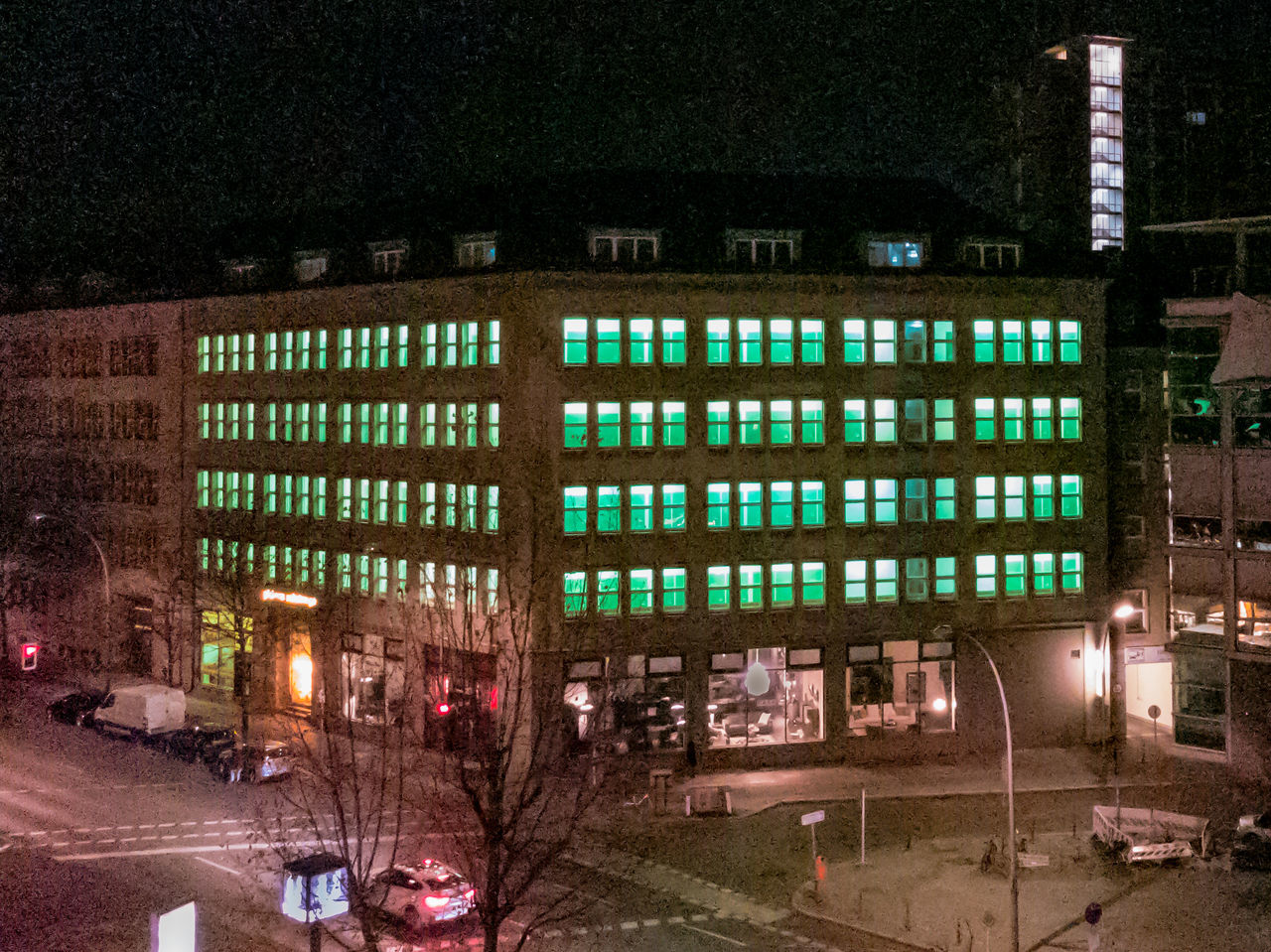 VIEW OF ILLUMINATED CITY STREET AT NIGHT