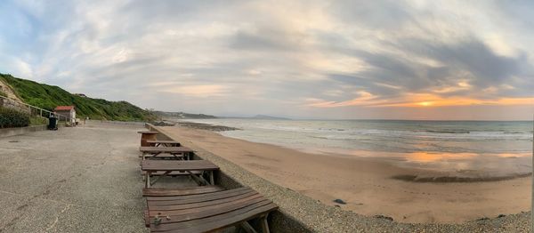 Scenic view of beach against sky during sunset