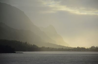 Scenic view of lake and mountains against sky