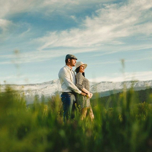 lifestyles, leisure activity, sky, casual clothing, person, young adult, young men, landscape, field, full length, three quarter length, cloud - sky, sunglasses, nature, standing, grass, smiling