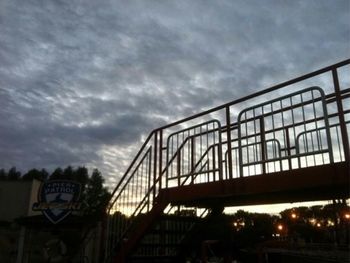 Low angle view of bridge against cloudy sky