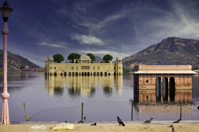 View of jal mahal building against cloudy sky in jaipur