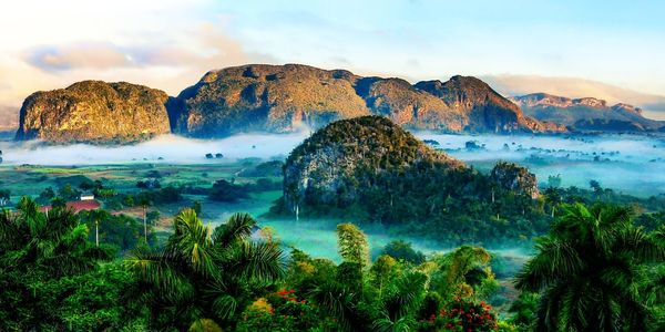 Scenic view of sea and mountains against sky