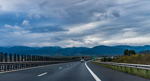 View of highway against cloudy sky