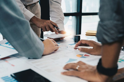 Midsection of business colleagues working at office