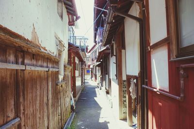 Alley amidst houses in city