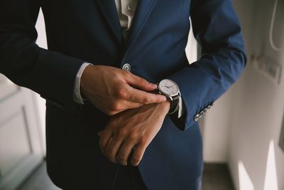 Midsection of businessman wearing suit