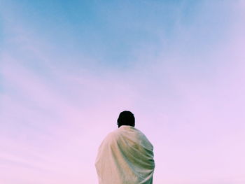 Low angle view of man against pink sky
