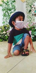 Portrait of boy sitting on floor