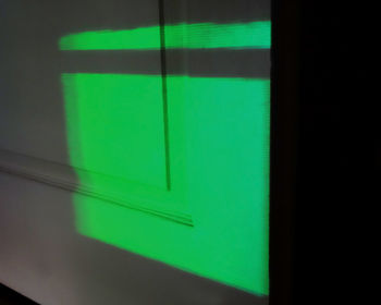 Close-up of green light against wall
