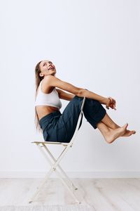 Portrait of young woman exercising on floor