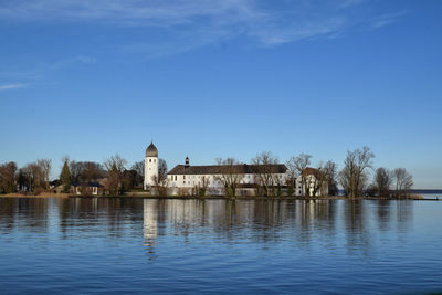 Scenic view of lake by building against sky