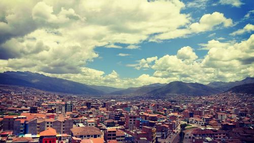 High angle shot of townscape against cloudy sky