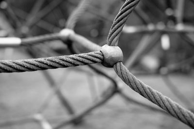 Close-up of rope tied to metal fence