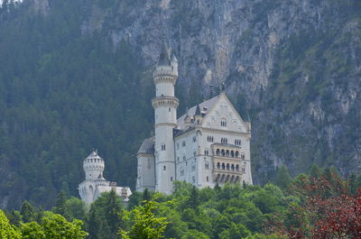 View of trees and buildings against mountain