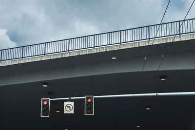 Low angle view of signal against bridge