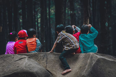 Rear view of people in forest