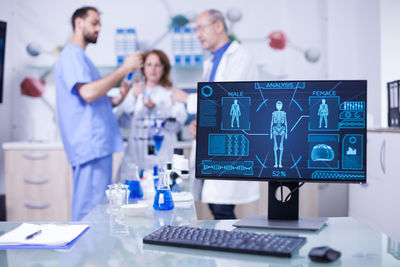 Portrait of woman using laptop at clinic