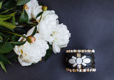 Directly above shot of white flowers by decoration on table