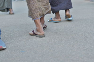 Low section of people standing on street