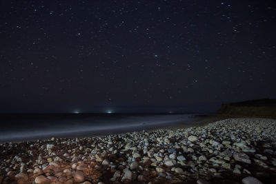 Scenic view of sea against sky at night