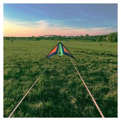 Scenic view of grassy field against cloudy sky