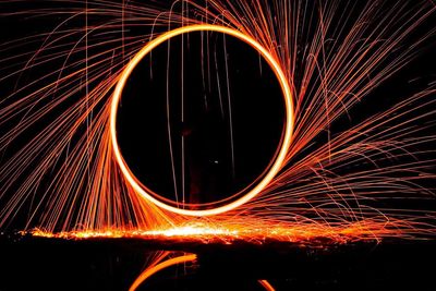 Wire wool over sea at night