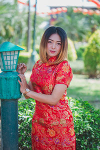 Portrait of smiling woman standing outdoors