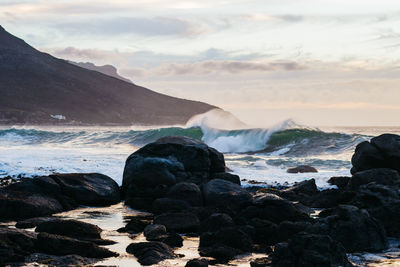 Scenic view of sea and mountains against sky