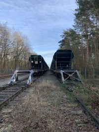 View of railroad tracks on field against sky