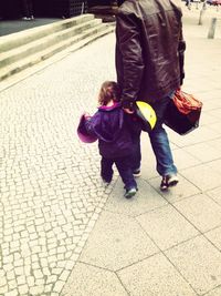 Woman standing on footpath